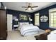 Stylish bedroom with navy blue walls, sporty decor, and a comfortable bed with decorative pillows at 4101 John S Raboteau Wynd, Raleigh, NC 27612
