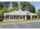 A brick clubhouse with white trim accents, a copper-topped cupola, and a neatly landscaped front yard at 4101 John S Raboteau Wynd, Raleigh, NC 27612