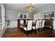 Elegant dining room with hardwood floors, a chandelier, and wainscoting on the walls at 4101 John S Raboteau Wynd, Raleigh, NC 27612