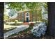 Traditional brick home with manicured landscaping, walkway and mature trees creating a park-like setting at 4101 John S Raboteau Wynd, Raleigh, NC 27612