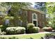 Beautiful brick home featuring a black front door, manicured landscaping and steps leading to the entrance at 4101 John S Raboteau Wynd, Raleigh, NC 27612
