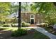 Brick home with a landscaped yard, a pathway leading to the front door, and surrounded by mature trees at 4101 John S Raboteau Wynd, Raleigh, NC 27612