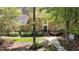 Brick home with mature trees, a walkway to the front door, and a lush, green lawn at 4101 John S Raboteau Wynd, Raleigh, NC 27612