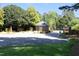 Community entrance with a brick guardhouse and secure gate, surrounded by mature trees at 4101 John S Raboteau Wynd, Raleigh, NC 27612