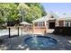 Community hot tub with a black metal fence that surrounds an in-ground community pool and pergola at 4101 John S Raboteau Wynd, Raleigh, NC 27612
