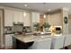 Bright kitchen features a large island, pendant lighting, and stainless steel appliances at 4101 John S Raboteau Wynd, Raleigh, NC 27612