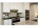 Modern kitchen featuring stainless steel appliances, a gas range, and a granite countertop at 4101 John S Raboteau Wynd, Raleigh, NC 27612