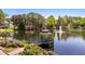 Scenic lake view with a gazebo, fountain, and lush landscaping creating a serene environment at 4101 John S Raboteau Wynd, Raleigh, NC 27612