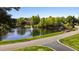 Scenic view of community lake with a fountain and gazebo nestled amongst lush greenery at 4101 John S Raboteau Wynd, Raleigh, NC 27612