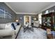 Comfortable living room boasts neutral tones, large windows, and a stylish rug at 4101 John S Raboteau Wynd, Raleigh, NC 27612