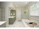 Bright main bathroom with a soaking tub, walk-in shower and double sink vanity at 4101 John S Raboteau Wynd, Raleigh, NC 27612