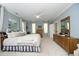 Large main bedroom features light blue walls, neutral carpet and three windows with curtains at 4101 John S Raboteau Wynd, Raleigh, NC 27612