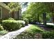 Lush landscaping, manicured lawn and a walkway that lines the side of this lovely brick home at 4101 John S Raboteau Wynd, Raleigh, NC 27612