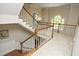Spacious landing featuring a staircase with wood and white trim and large arched window at 4101 John S Raboteau Wynd, Raleigh, NC 27612