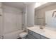 Bright bathroom features a shower-tub combo, neutral colors, vanity with storage, and a large mirror at 45 High Hampton Way, Fuquay Varina, NC 27526