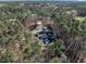 Aerial view showcasing a beautiful property surrounded by dense, mature trees providing privacy and a sense of seclusion at 464 Rosemont Dr, Durham, NC 27713