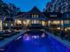 A backyard with a patio with lounge chairs surrounding the pool and a built-in hot tub at 464 Rosemont Dr, Durham, NC 27713