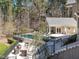 Aerial view of a backyard featuring a swimming pool, a pool house, a fire pit, and beautiful landscaping at 464 Rosemont Dr, Durham, NC 27713