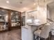 Stylish bar area with granite countertops, pendant lights, and a glass-enclosed wine cellar, perfect for entertaining at 464 Rosemont Dr, Durham, NC 27713