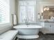 Bathroom featuring soaking tub, vanity with granite countertops, and natural light at 464 Rosemont Dr, Durham, NC 27713
