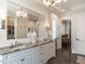 Bathroom featuring granite countertops, dual sinks, and a large mirror at 464 Rosemont Dr, Durham, NC 27713