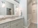 Bright bathroom features a granite countertop and white cabinetry, with a bathtub and shower visible in the background at 464 Rosemont Dr, Durham, NC 27713