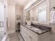 Elegant bathroom featuring a double vanity with marble countertop, a large mirror, and a glass-enclosed shower at 464 Rosemont Dr, Durham, NC 27713