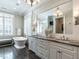 Bathroom featuring a soaking tub, vanity with granite countertops, and a large mirror at 464 Rosemont Dr, Durham, NC 27713