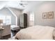 Serene bedroom with a seating area, neutral color palette, and a glimpse into the bathroom at 464 Rosemont Dr, Durham, NC 27713