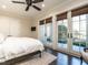 Bright bedroom with hardwood floors, a ceiling fan, and French doors leading to an outdoor patio at 464 Rosemont Dr, Durham, NC 27713