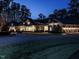 Stunning exterior shot of home with attached garages and circular drive at twilight at 464 Rosemont Dr, Durham, NC 27713