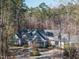 Charming exterior view of a stunning residence surrounded by beautiful trees and a well-manicured lawn and driveway at 464 Rosemont Dr, Durham, NC 27713
