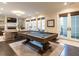 Spacious game room with a pool table, fireplace, and french doors leading to an outdoor space at 464 Rosemont Dr, Durham, NC 27713