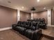 A home theater featuring tiered seating with leather recliners, a projector, and soft, neutral colors at 464 Rosemont Dr, Durham, NC 27713