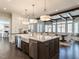 Spacious kitchen with island, farmhouse sink, stainless appliances, and a view of the dining room at 464 Rosemont Dr, Durham, NC 27713