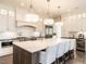 Spacious kitchen island with seating, designer lighting, and abundant cabinet space at 464 Rosemont Dr, Durham, NC 27713