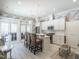 Bright and stylish kitchen with white cabinetry, stainless steel appliances, and a cozy seating area and outdoor access at 464 Rosemont Dr, Durham, NC 27713