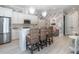 Stylish kitchen featuring white cabinetry, stainless steel appliances, an island with seating and unique wallpaper at 464 Rosemont Dr, Durham, NC 27713