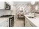 Charming kitchen with white cabinets, stainless steel appliances, granite countertops, and colorful wallpaper and accents at 464 Rosemont Dr, Durham, NC 27713