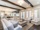 Bright and open living room with wood beam ceilings and seamless transition to dining and kitchen at 464 Rosemont Dr, Durham, NC 27713