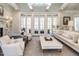 Open concept living room with fireplace and multiple French doors leading to the outside at 464 Rosemont Dr, Durham, NC 27713