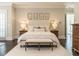 Bright main bedroom featuring a bench at the foot of the bed and hardwood flooring at 464 Rosemont Dr, Durham, NC 27713
