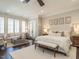 Spacious main bedroom featuring hardwood floors, seating area, and French doors to outdoor porch at 464 Rosemont Dr, Durham, NC 27713