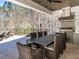 Beautiful outdoor patio area with full dining area, stainless steel grill, exhaust hood and ceiling fan at 464 Rosemont Dr, Durham, NC 27713