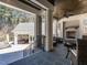 Spacious covered outdoor living area with a fireplace, comfortable seating, and view to additional outdoor amenities at 464 Rosemont Dr, Durham, NC 27713
