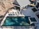 Aerial view of the in-ground pool and hot tub with tanning chairs surrounding the pool and outdoor kitchen at 464 Rosemont Dr, Durham, NC 27713