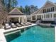 Luxury home featuring a spacious swimming pool, lounge chairs, outdoor kitchen and beautiful outdoor entertaining area at 464 Rosemont Dr, Durham, NC 27713