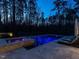Backyard shot showing pool and hot tub with deck chairs and natural landscaping at 464 Rosemont Dr, Durham, NC 27713