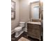 Elegant powder room featuring a decorative mirror, furniture-style vanity, and neutral decor at 464 Rosemont Dr, Durham, NC 27713