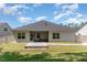 Home's rear exterior showcasing a screened porch and deck area in the backyard at 49 Parkside Dr, Lillington, NC 27546